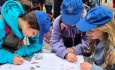 students using workbooks on market mission