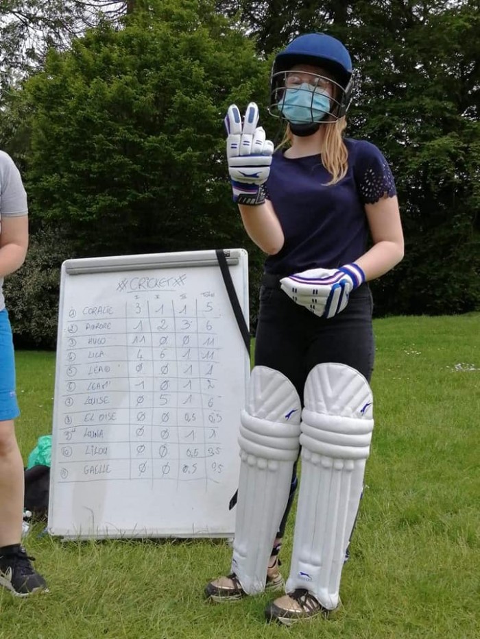 Learning cricket girl in cricket pads