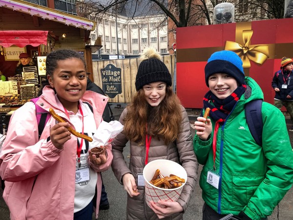 Students eat churros at Lille Christmas market 2021