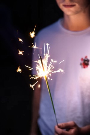 Child with a sparkler celebrating winter festivities in France