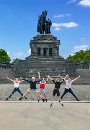 Kids jumping in front of statue Koblenz resized
