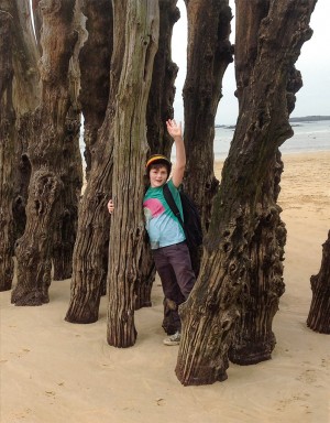 Student waving Normandy beach