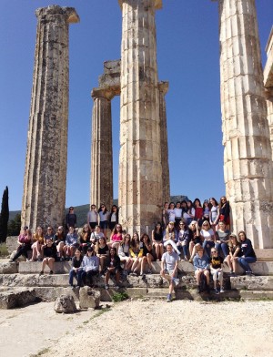 Students sitting by Greek columns